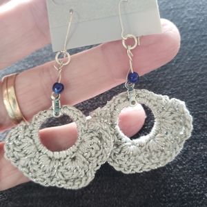 Earrings-Hand crocheted by me in silver thread with dark blue bead.